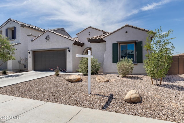 9723 W Patrick Ln, Peoria, AZ 85383 - mediterranean / spanish-style home featuring driveway, an attached garage, stucco siding, and a tile roof