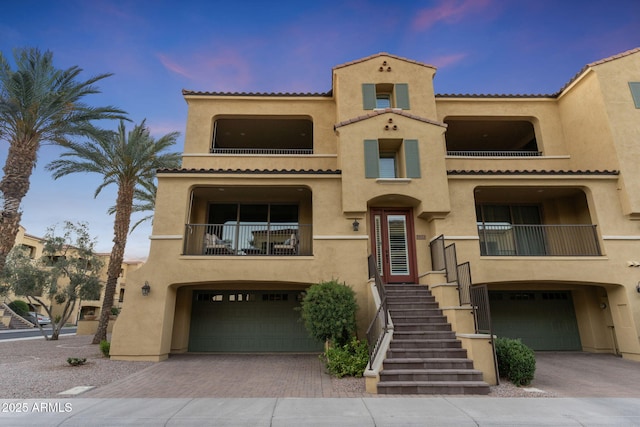 7122 W Ivanhoe St, Chandler, AZ 85226 - view of front facade featuring a balcony, stucco siding, an attached garage, decorative driveway, and a tiled roof