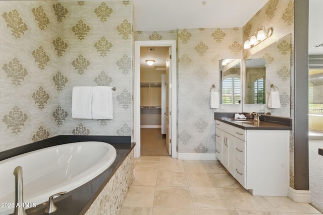 7122 W Ivanhoe St, Chandler, AZ 85226 - full bathroom featuring wallpapered walls, vanity, a walk in closet, a garden tub, and baseboards