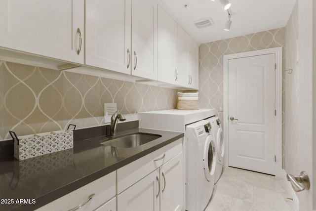 7122 W Ivanhoe St, Chandler, AZ 85226 - laundry area with cabinet space, separate washer and dryer, wallpapered walls, and rail lighting