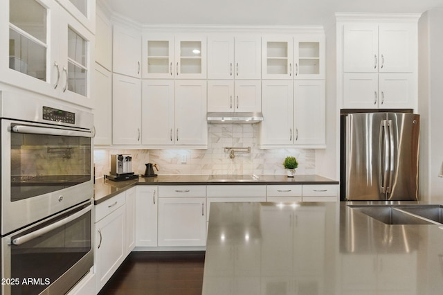 7122 W Ivanhoe St, Chandler, AZ 85226 - kitchen featuring appliances with stainless steel finishes, white cabinetry, tasteful backsplash, dark countertops, and glass insert cabinets