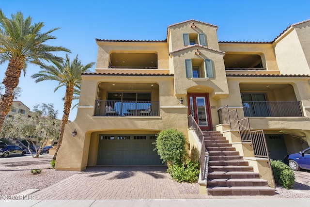 7122 W Ivanhoe St, Chandler, AZ 85226 - mediterranean / spanish home with a balcony, stucco siding, a garage, a tiled roof, and decorative driveway