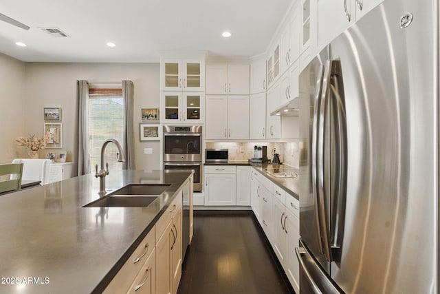 7122 W Ivanhoe St, Chandler, AZ 85226 - kitchen with stainless steel appliances, a sink, dark wood-style flooring, glass insert cabinets, and recessed lighting