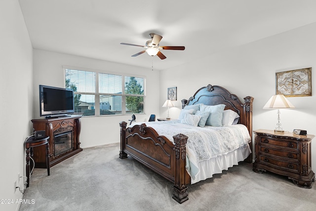 carpeted bedroom with a ceiling fan and baseboards