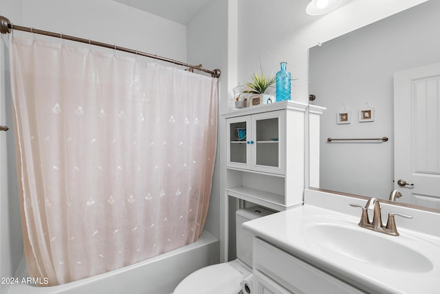 bathroom featuring vanity, shower / bathtub combination with curtain, and toilet