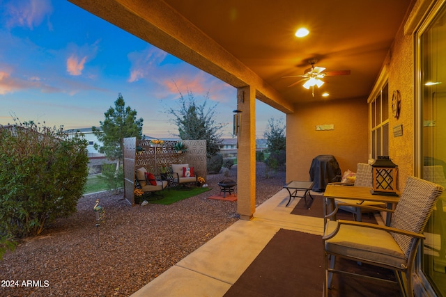 patio terrace at dusk featuring ceiling fan