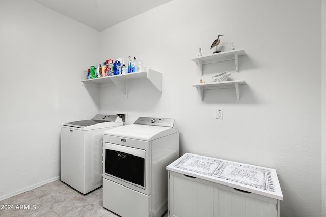 laundry room with separate washer and dryer, baseboards, and laundry area