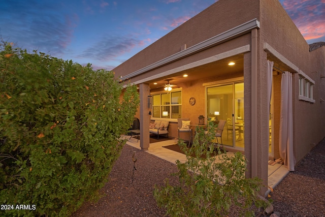 back of property featuring a patio, stucco siding, and an outdoor hangout area