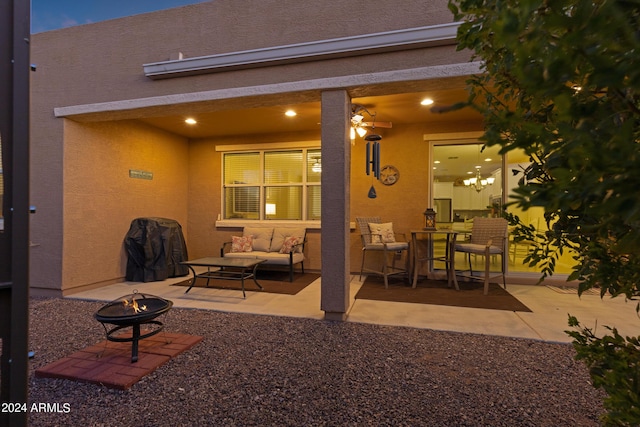 view of patio with an outdoor living space with a fire pit
