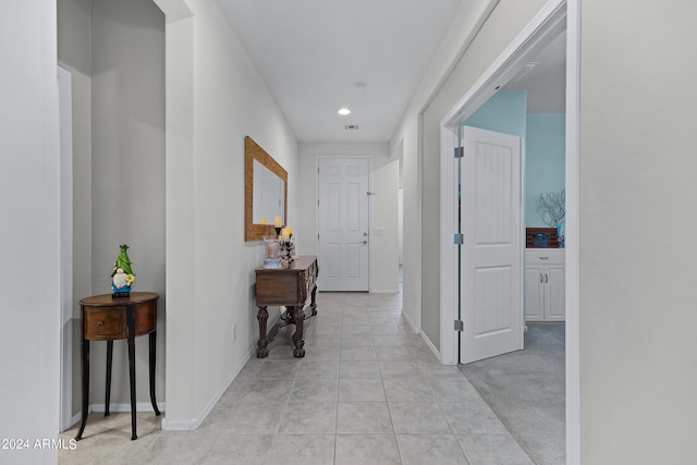 corridor with baseboards, recessed lighting, light tile patterned flooring, and visible vents