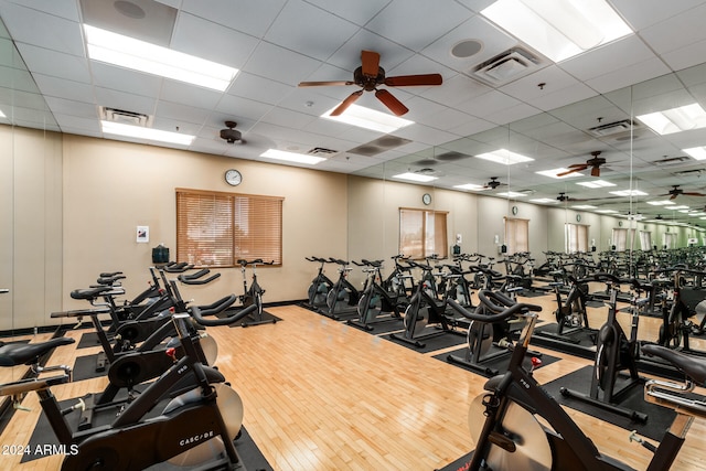 gym featuring a paneled ceiling and wood-type flooring