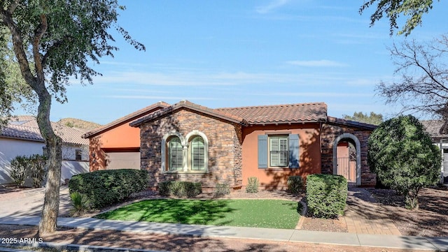 mediterranean / spanish house with a garage and a front lawn