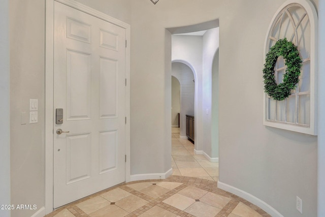 foyer entrance featuring light tile patterned floors