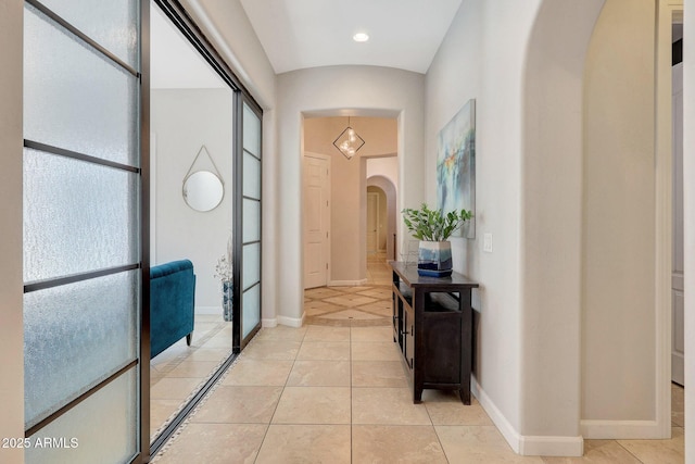 hall featuring light tile patterned floors