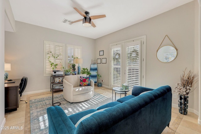 tiled living room featuring ceiling fan and a wealth of natural light