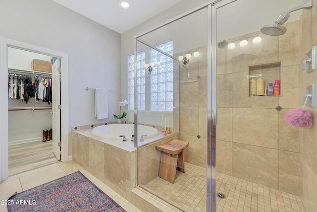 bathroom featuring shower with separate bathtub and tile patterned flooring