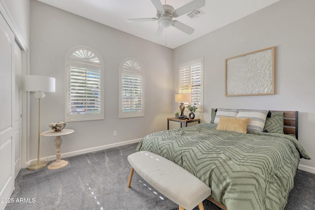 bedroom with ceiling fan, a closet, and dark colored carpet