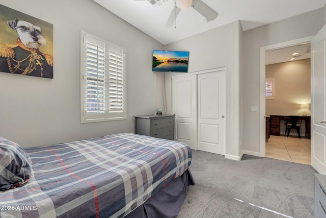 carpeted bedroom featuring a closet and ceiling fan