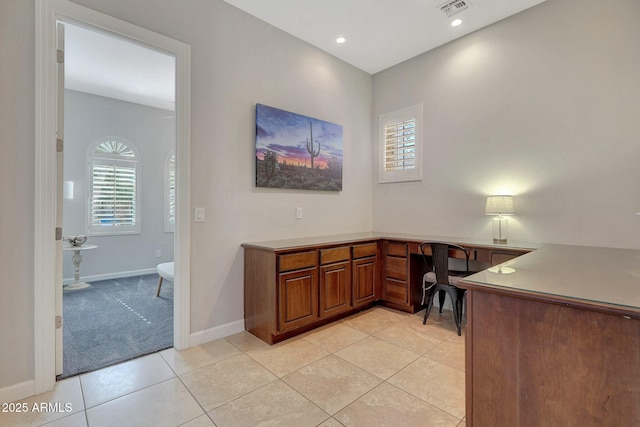 tiled office space featuring built in desk