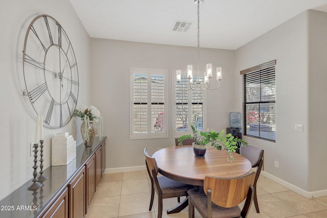 dining area featuring light tile patterned floors and an inviting chandelier