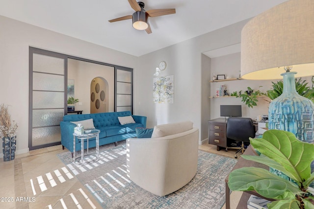 living room featuring ceiling fan and light tile patterned floors