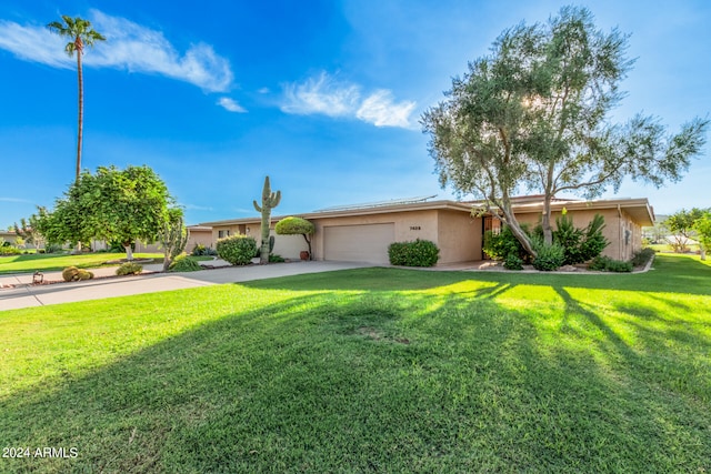 single story home featuring a garage and a front lawn