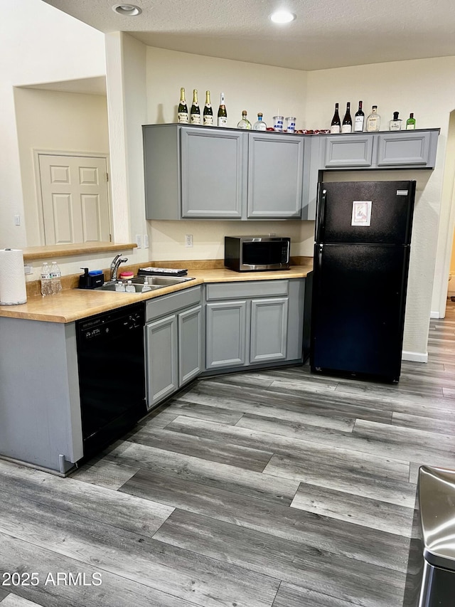 10489 S 182nd Dr, Goodyear, AZ 85338 - kitchen featuring light countertops, a sink, black appliances, and gray cabinets