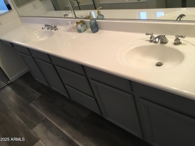 10489 S 182nd Dr, Goodyear, AZ 85338 - bathroom with a sink, double vanity, and wood finished floors