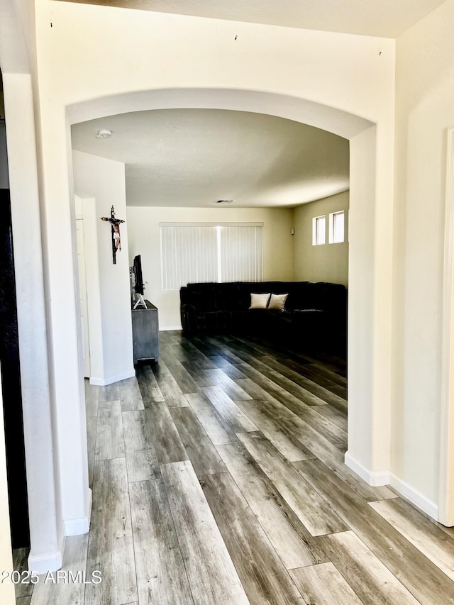 10489 S 182nd Dr, Goodyear, AZ 85338 - hall with arched walkways, wood finished floors, and baseboards