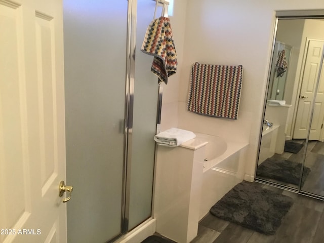 10489 S 182nd Dr, Goodyear, AZ 85338 - bathroom with a shower stall, a bath, and wood finished floors