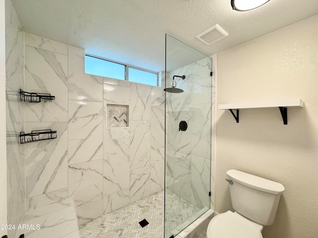 bathroom featuring toilet and walk in shower