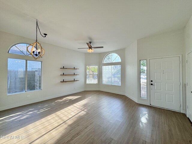 entrance foyer featuring ceiling fan with notable chandelier and hardwood / wood-style floors