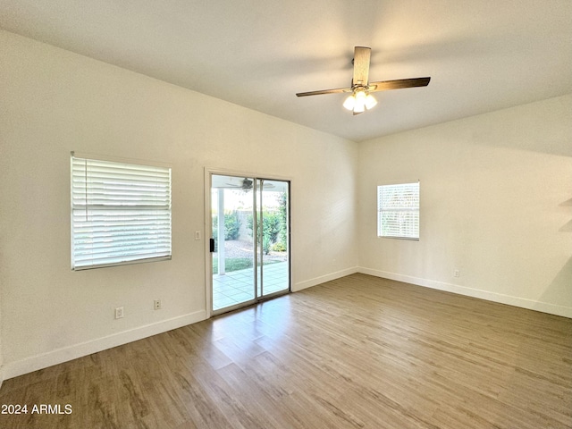 unfurnished room with a healthy amount of sunlight, hardwood / wood-style flooring, and ceiling fan