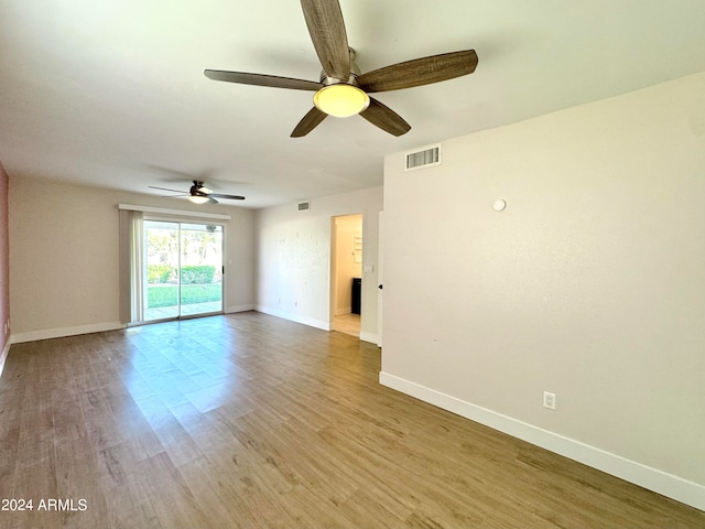 empty room with light hardwood / wood-style flooring and ceiling fan