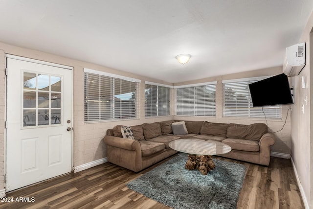 living room featuring a wall mounted air conditioner and dark hardwood / wood-style floors