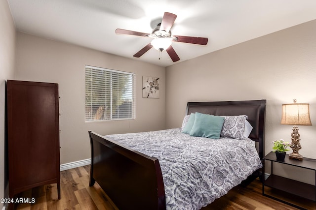 bedroom with ceiling fan and hardwood / wood-style flooring