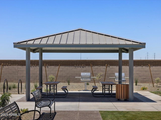 view of property's community with a gazebo, a patio area, and a fenced backyard