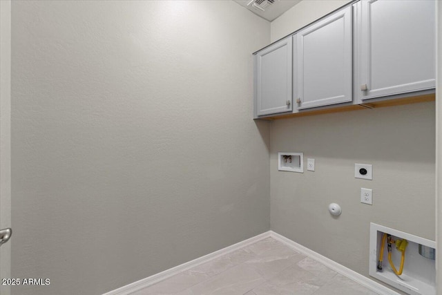 laundry room featuring cabinet space, hookup for a washing machine, marble finish floor, electric dryer hookup, and hookup for a gas dryer