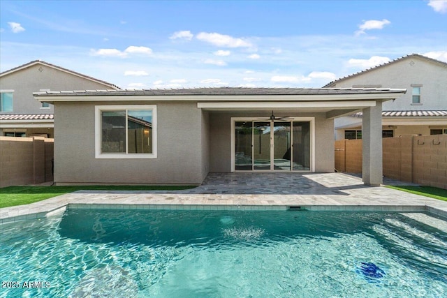 back of house with fence, a patio area, and a fenced in pool