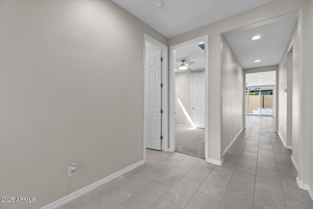 hall featuring baseboards and marble finish floor