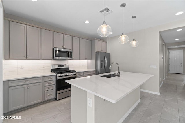 kitchen with a sink, gray cabinetry, stainless steel appliances, and visible vents