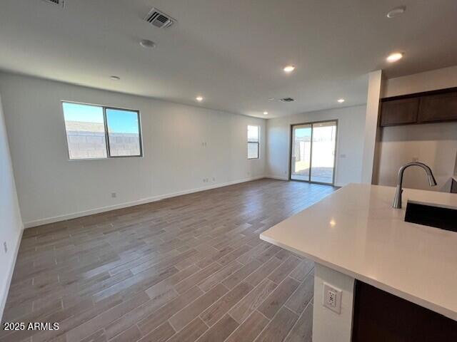 kitchen featuring dark brown cabinets, sink, and hardwood / wood-style floors