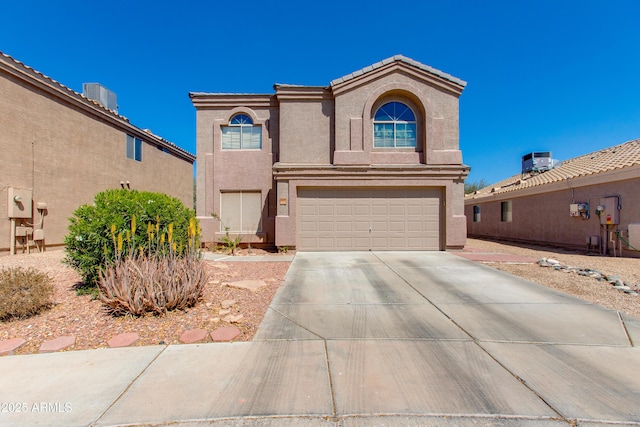 traditional-style home featuring stucco siding, an attached garage, central AC, and concrete driveway