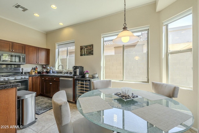 dining space featuring a wealth of natural light, visible vents, wine cooler, and light tile patterned flooring