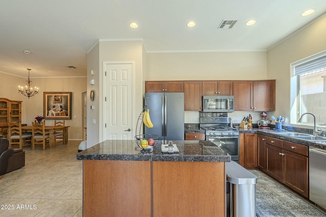 kitchen with a sink, tile counters, visible vents, and stainless steel appliances