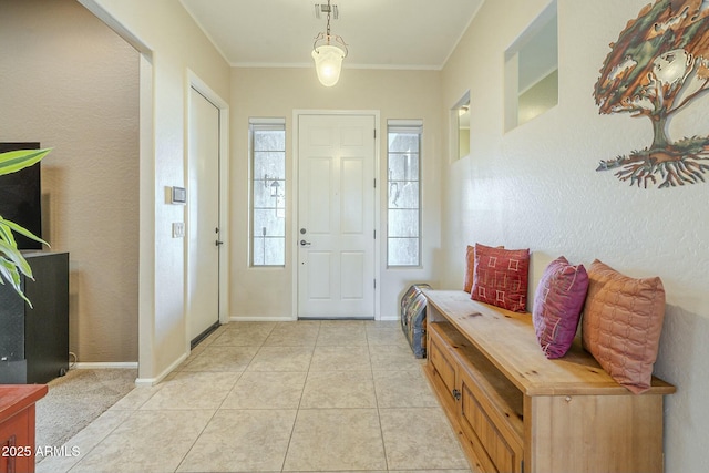 entrance foyer with light tile patterned flooring, visible vents, baseboards, and ornamental molding