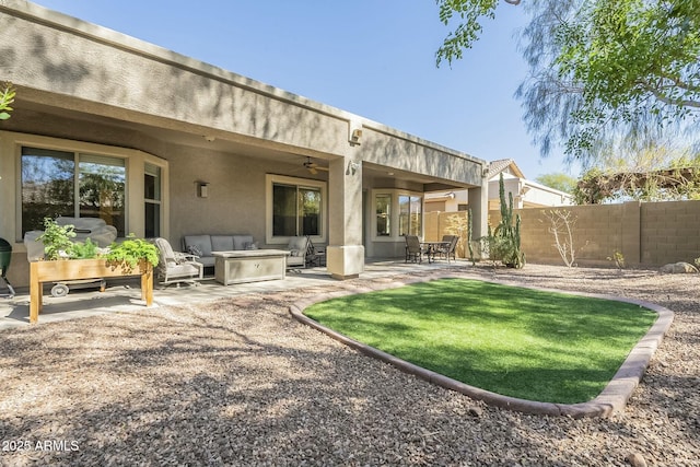 rear view of house with a ceiling fan, a patio area, fence, and stucco siding