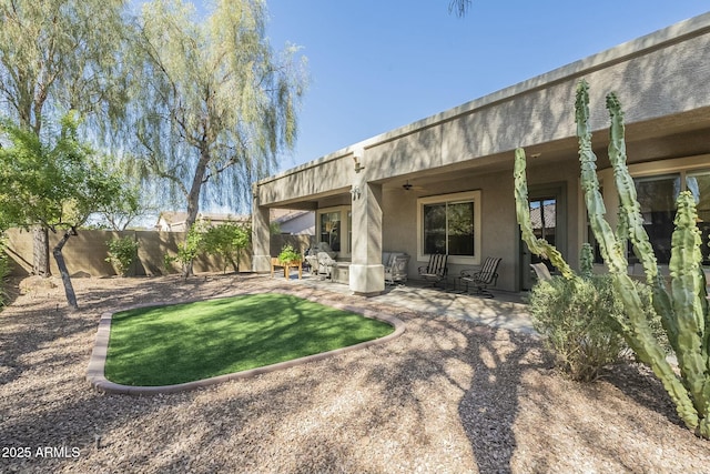 back of property featuring ceiling fan, a patio, a fenced backyard, and stucco siding