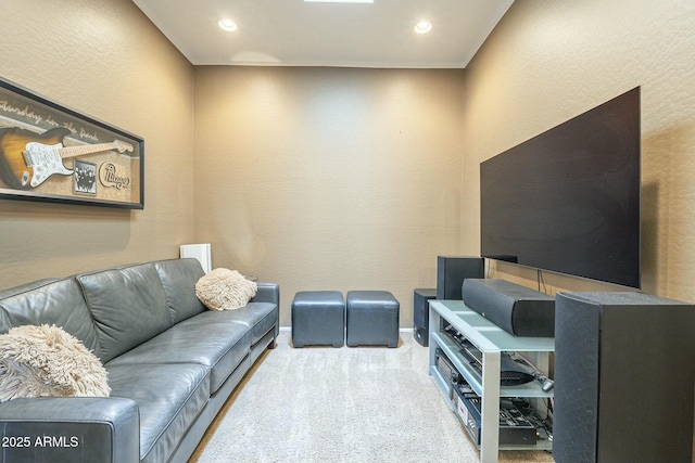 carpeted living area with recessed lighting, baseboards, and a textured wall