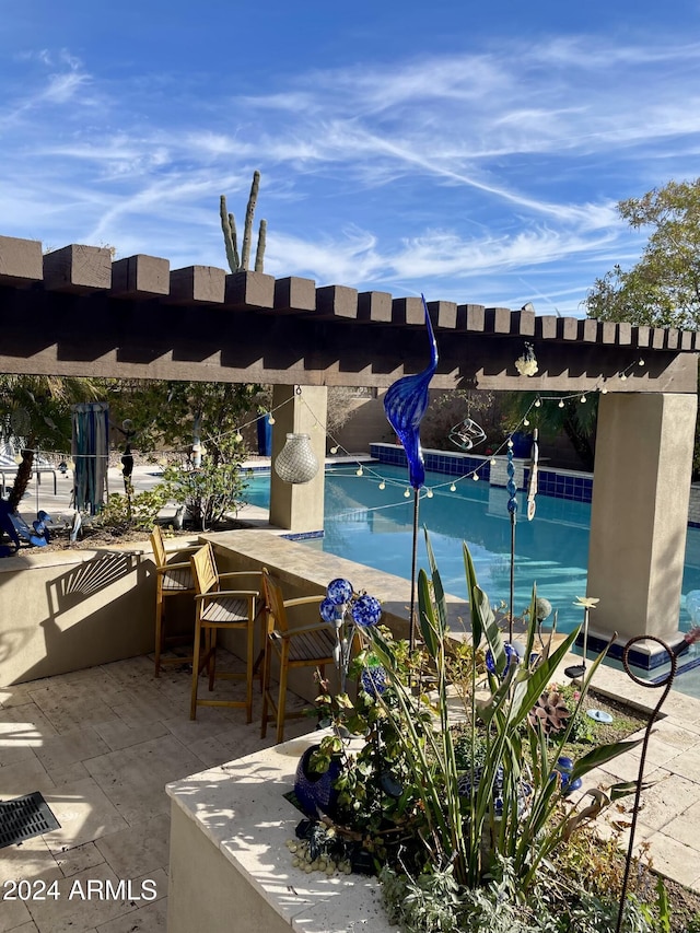 view of swimming pool with a patio area and a pergola